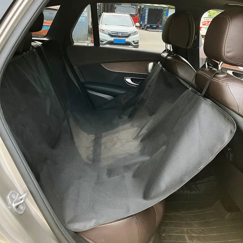 Dog car seat protector mat on rear bench seats in grey dog footprints pattern