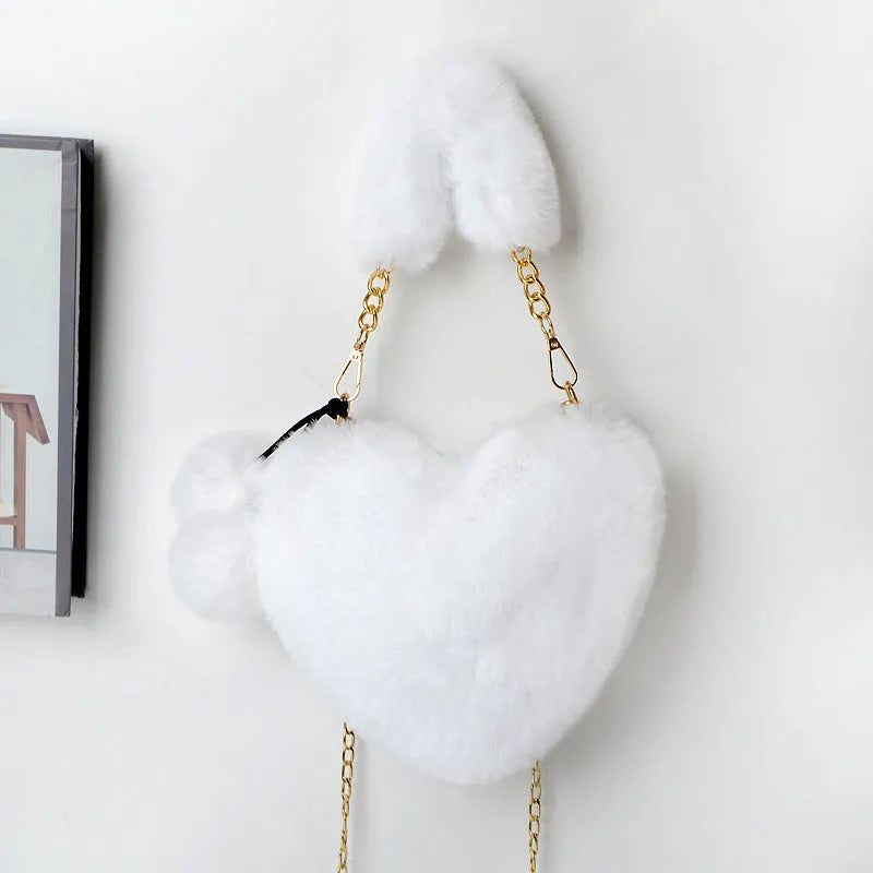 A soft plush heart-shaped women's handbag with a zipper and a detachable shoulder strap in a choice of 14 colours.