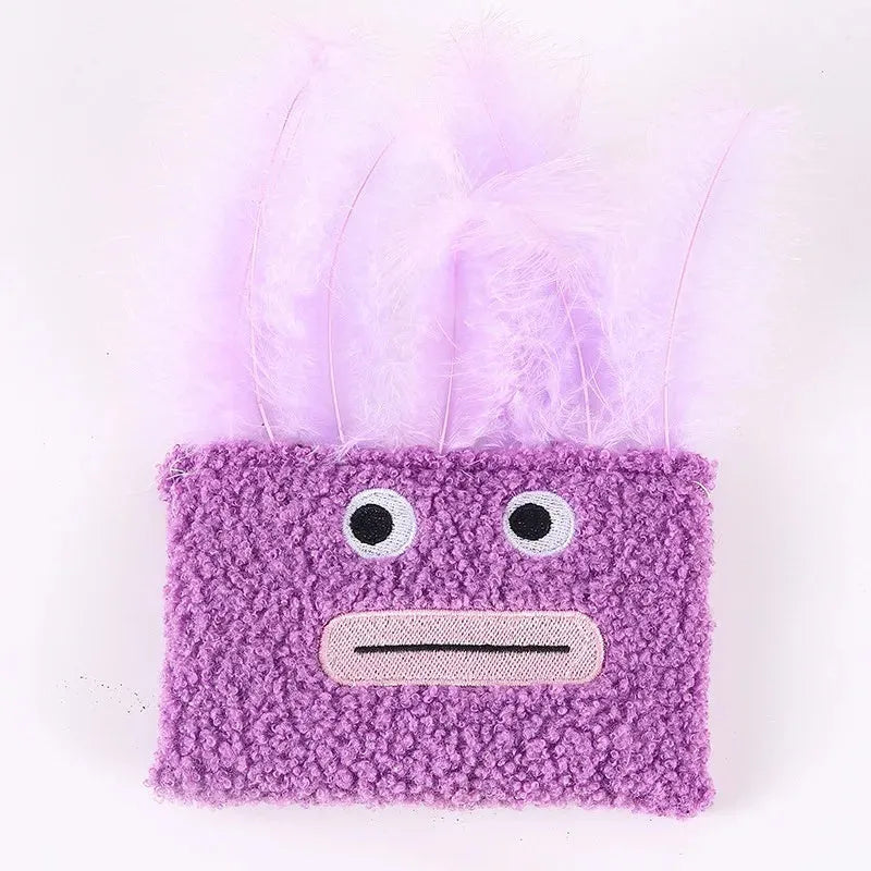 Colourful cat plush toy with a big mouth explosion head shape on a plain background.
