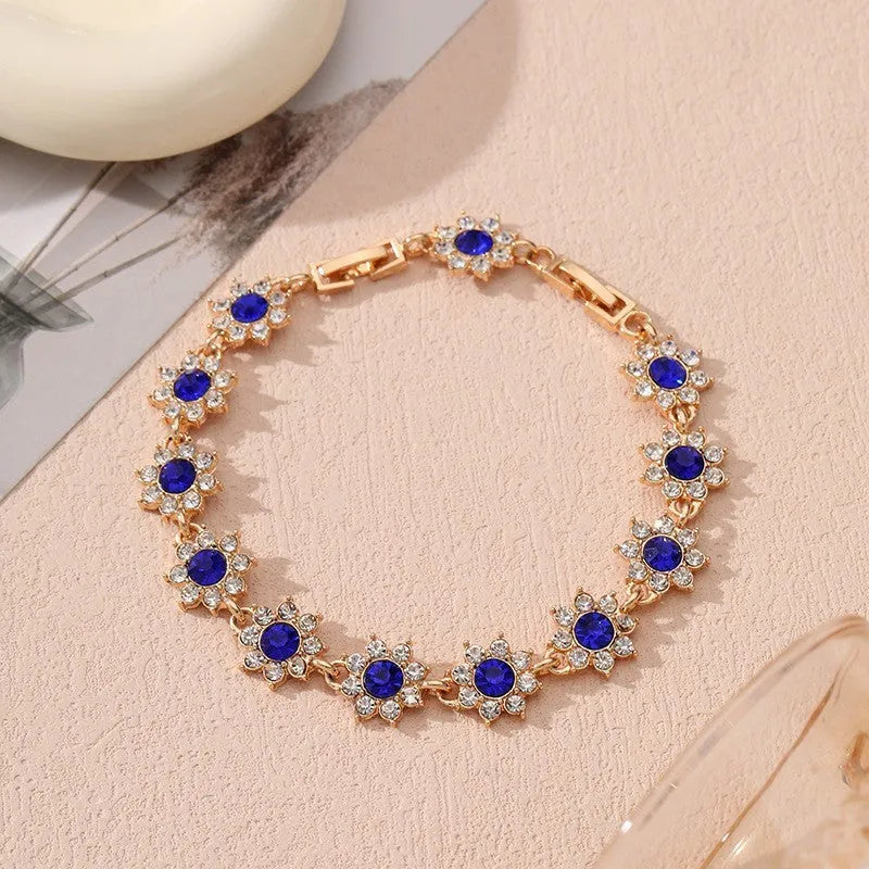Electroplated zinc alloy flower bracelet in a choice of gold or silver finishes with coloured gemstone designs.