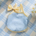 Small dog wearing heart bow suspenders vest in blue with elastic sides