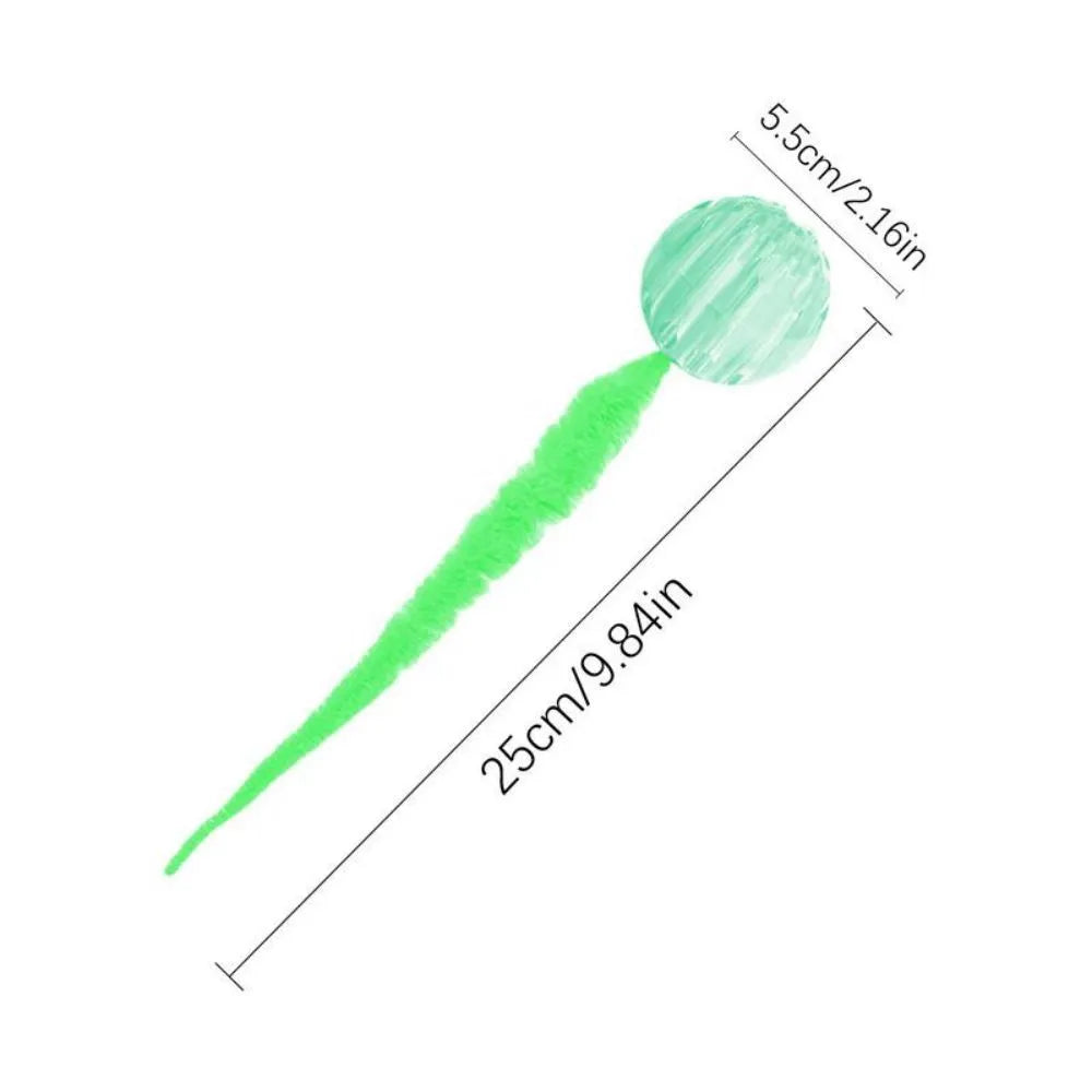 Green interactive cat toy featuring a bouncy ball with a long plush tail on a wooden floor.