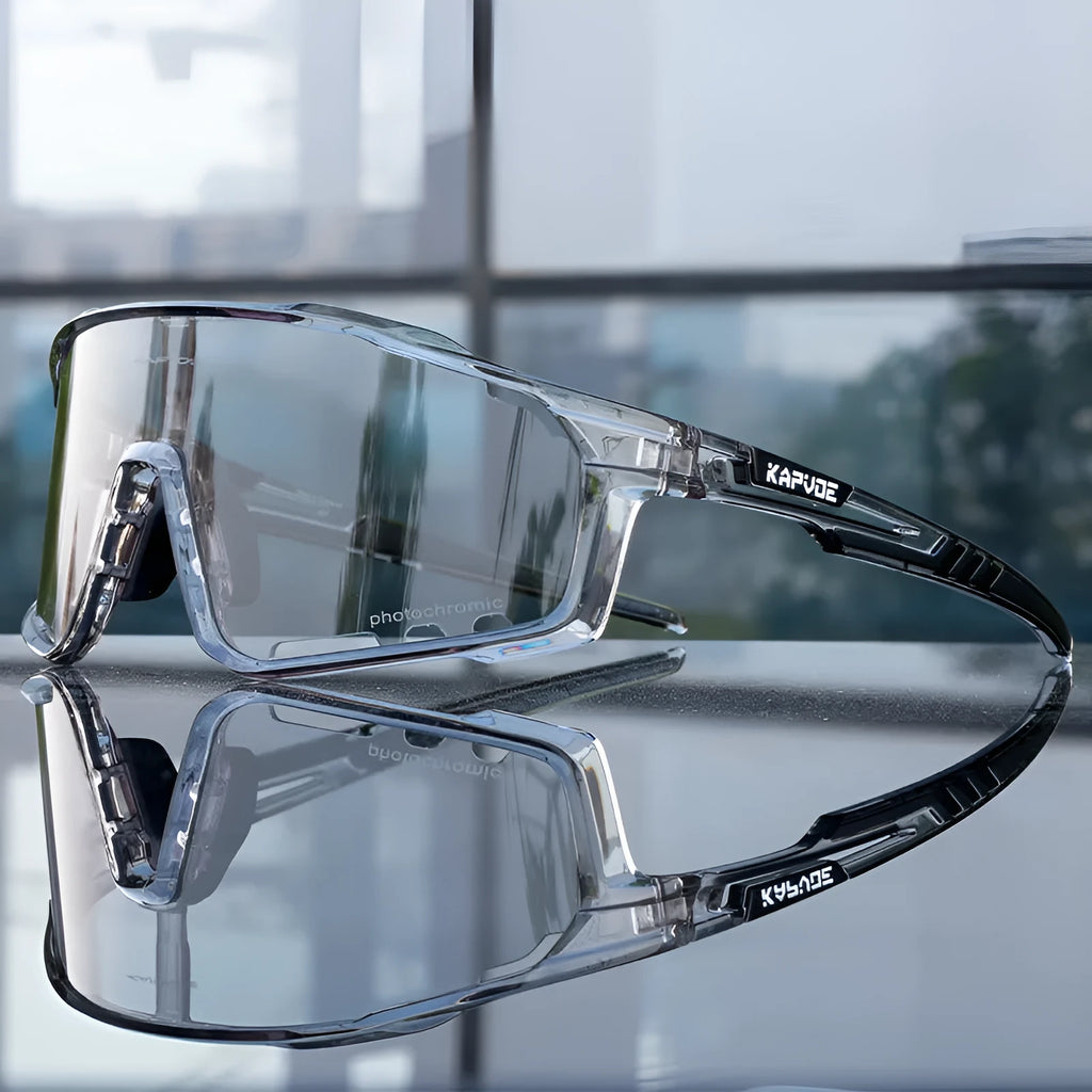 Photochromic cycling sunglasses with a semi-rimless TR90 frame on a solid colour background.