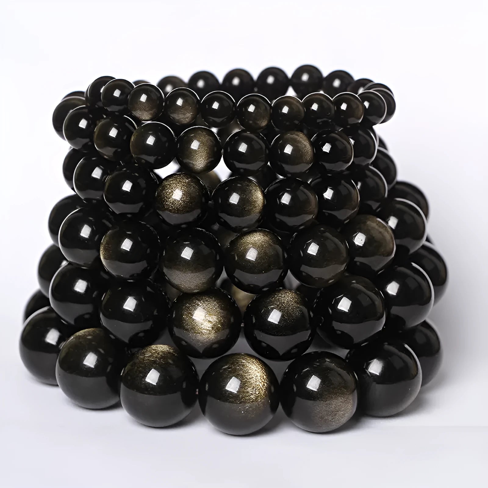 Hand-woven round obsidian bead bracelet in multiple colour options on a wrist.