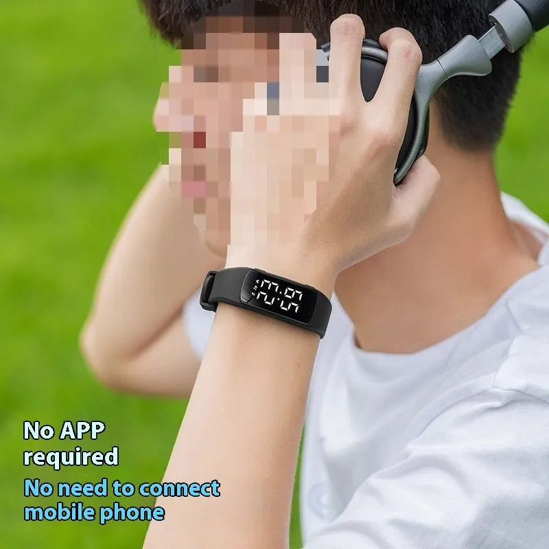 Black vibration alarm smart watch with LED display and silicone strap on a wrist.