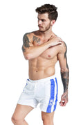Men's blue slim fit lace-up sports shorts made from stretch polyester with built-in padding.