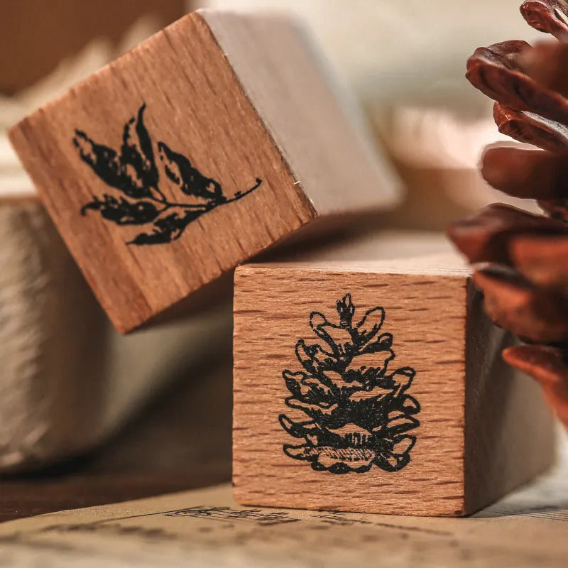 Set of seven wooden craft stamps for DIY journal decoration in stars and moon or plant catalog designs.