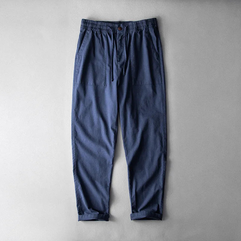 Men's casual linen trousers in solid colour with mid waist design available in navy blue, apricot linen, or grey