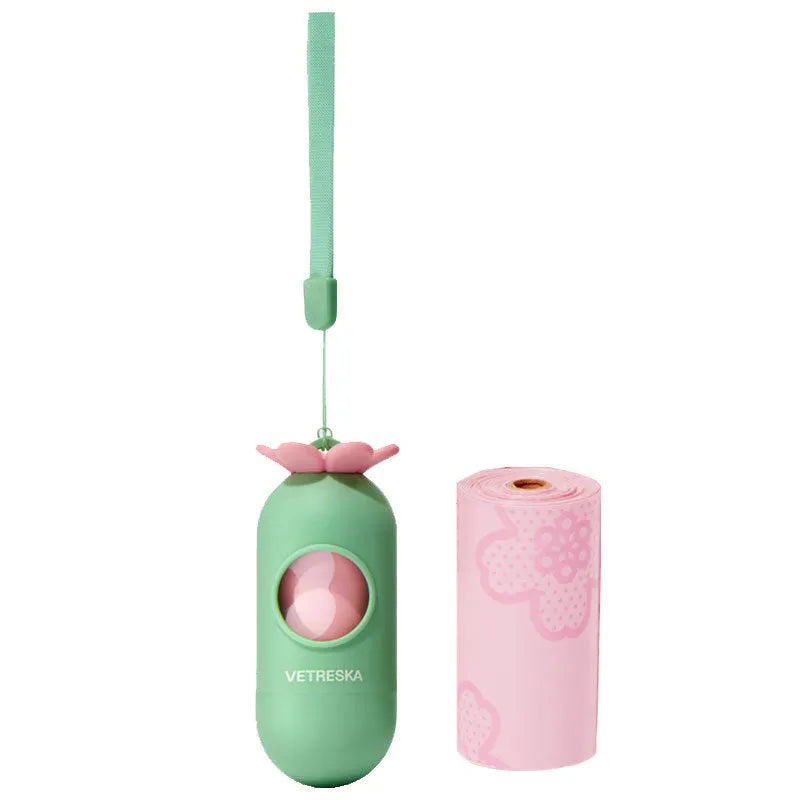 Portable dog poop bag dispenser capsule in strawberry, orange, and cherry blossom patterns with a roll of scented bags.