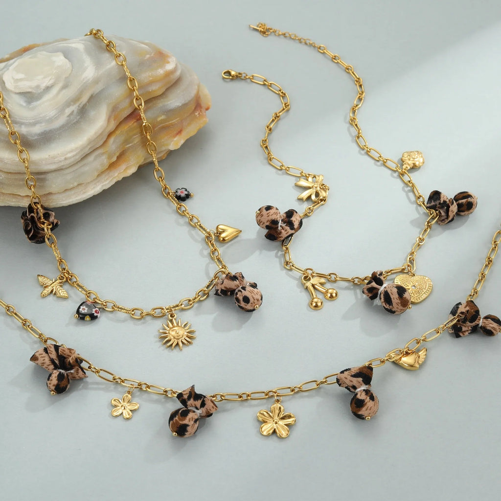 Women's stainless steel leopard pendant necklace with love heart and flower details on 41-50cm adjustable chain