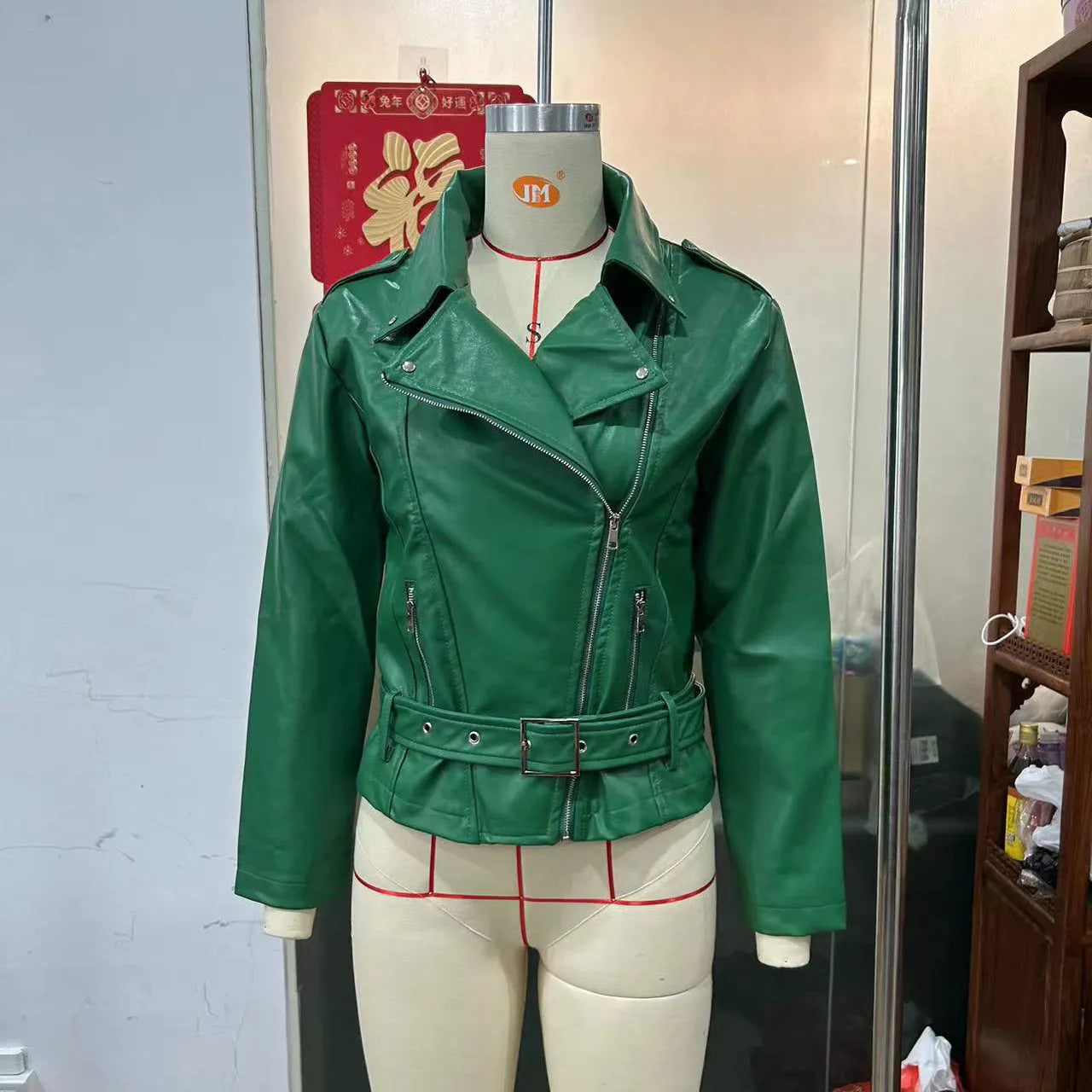 Black punk-style locomotive jacket with a drawstring waist, Peter Pan collar, and regular sleeves on a hanger.