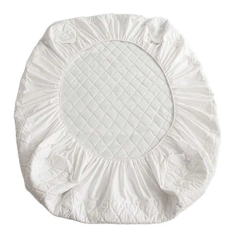 Diamond lattice quilted waterproof mattress protector in bamboo fibre shown on bed