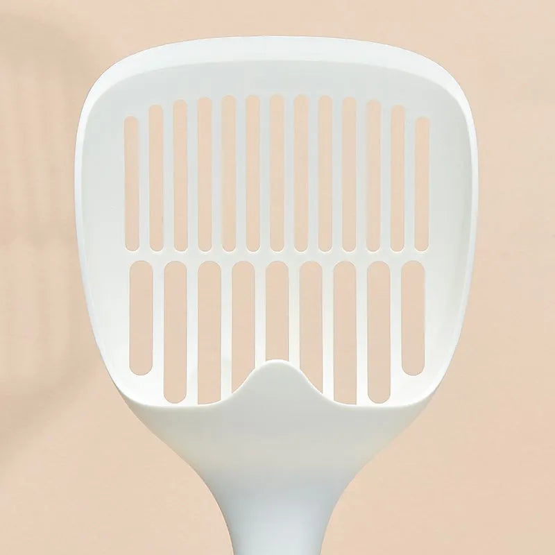 White plastic cat litter scoop with storage base on a clean surface