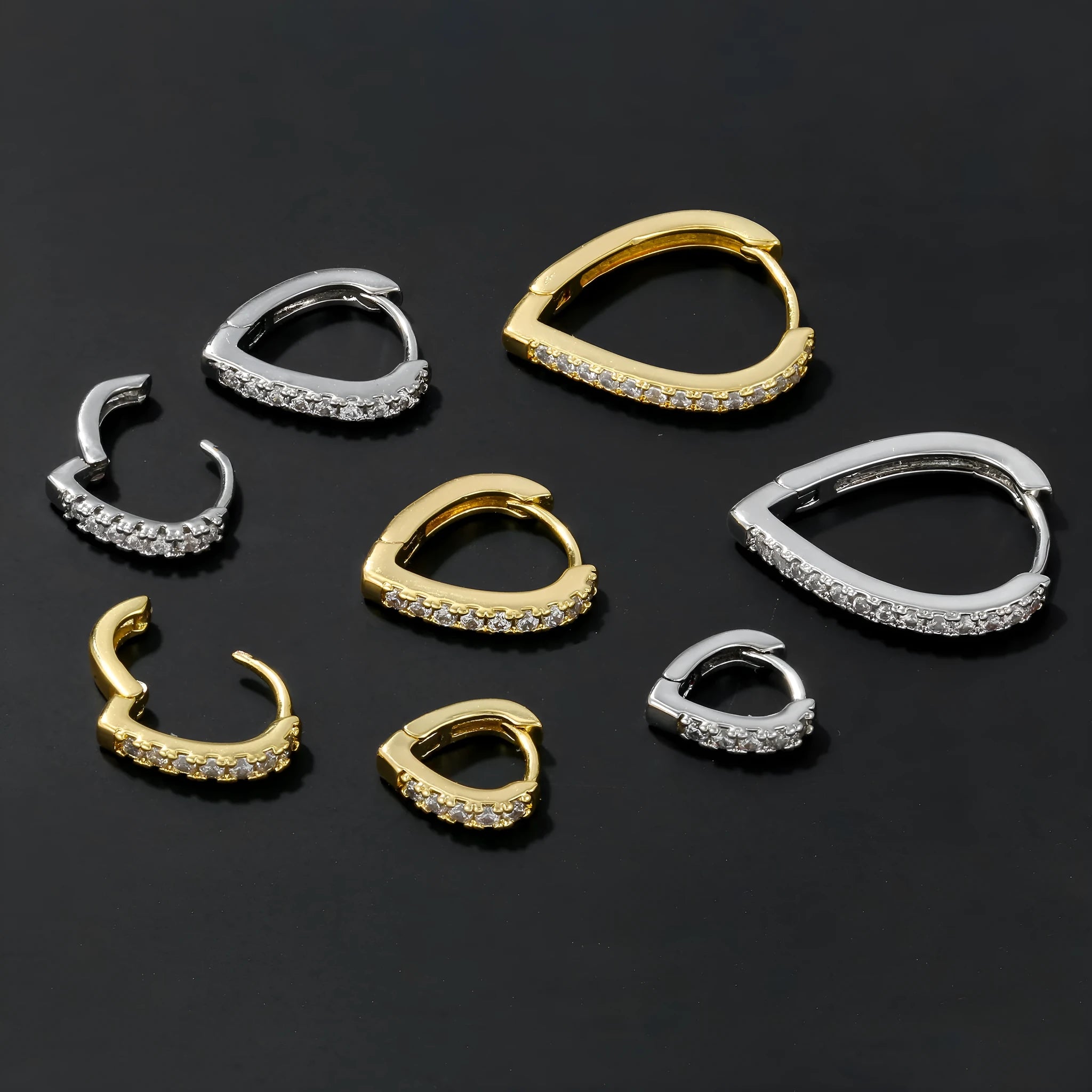 Geometric heart-shaped copper ear clip with electroplated gold finish, clip-on back visible