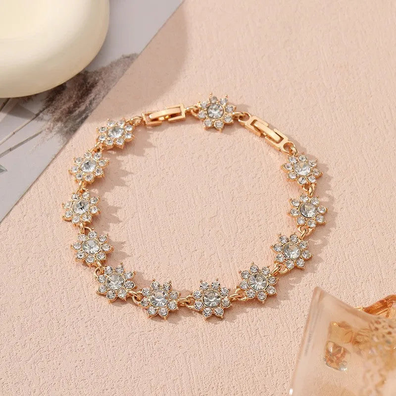 Electroplated zinc alloy flower bracelet in a choice of gold or silver finishes with coloured gemstone designs.