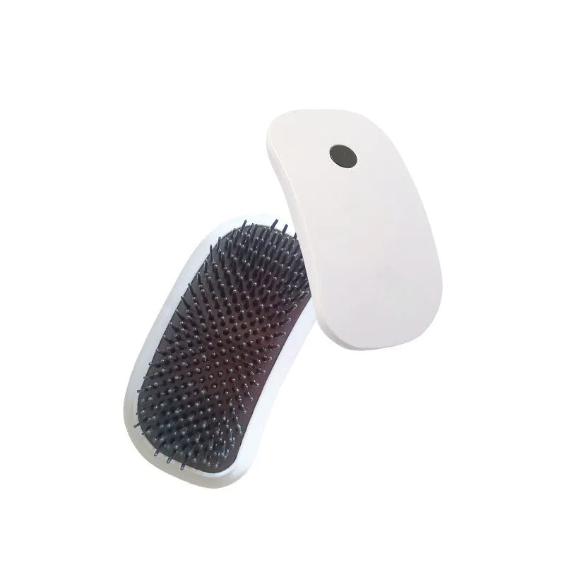 Pink handheld electric pet grooming brush with soft TPE teeth on a white background.