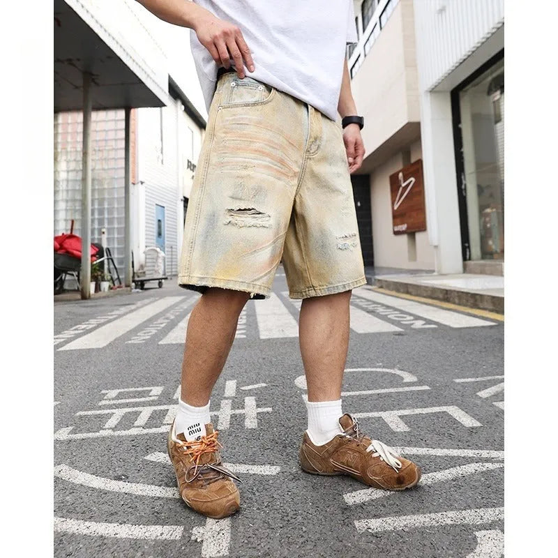 Men's light blue denim shorts with ripped detailing and a straight-leg cut.