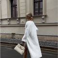 White women's cardigan sweater jacket with long sleeves and knitted texture