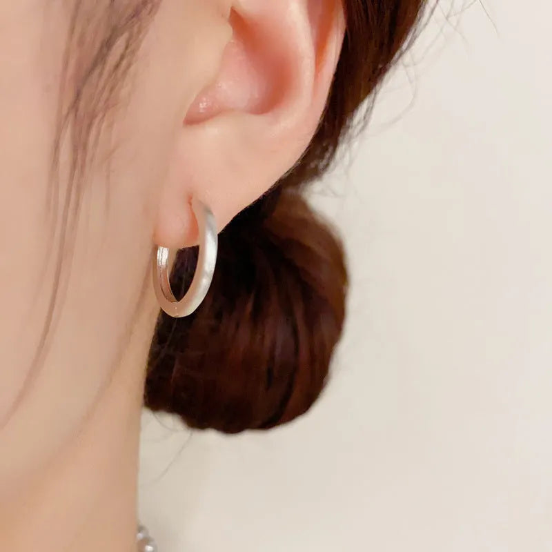 Women's geometric eyelet ear clip in gold or silver colour with round elements on copper base