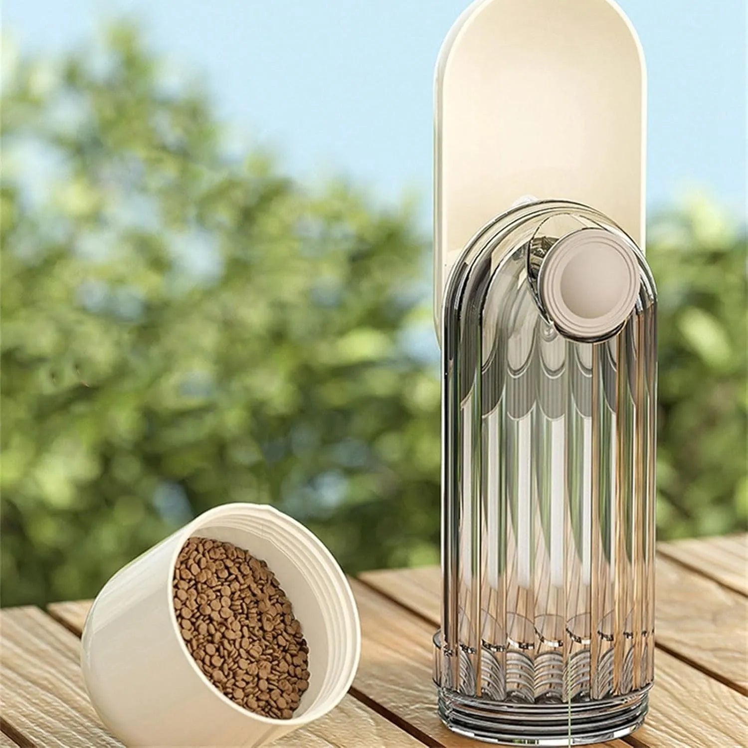 Beige and green foldable dog water bottle with food dispenser for outdoor use