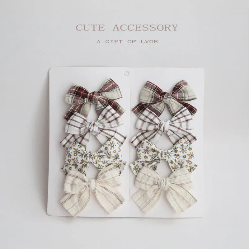 Children's fabric dovetail bow hair clips in eight pattern options