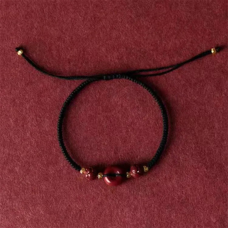 Cinnabar safety buckle bracelet with heart-shaped pendant on adjustable rope cord