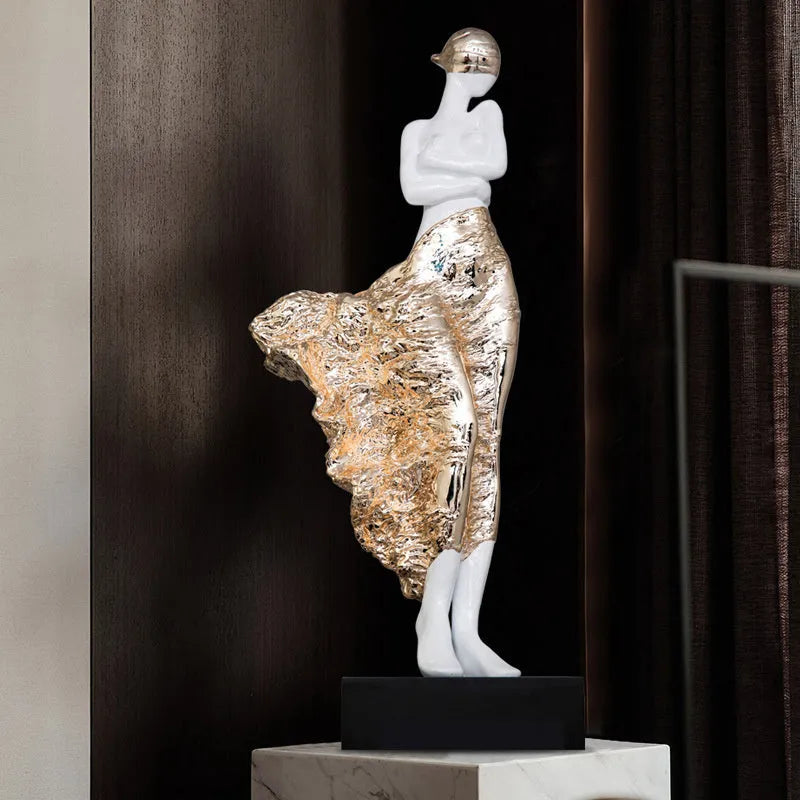 Tall gold resin character sculpture ornament with modern minimalist design on wooden surface