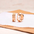 Rose gold electroplated earrings with three hollow heart shapes in circular arrangement