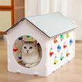 Plastic cat scratch board integrated with a nesting house and tunnel, includes a toy.