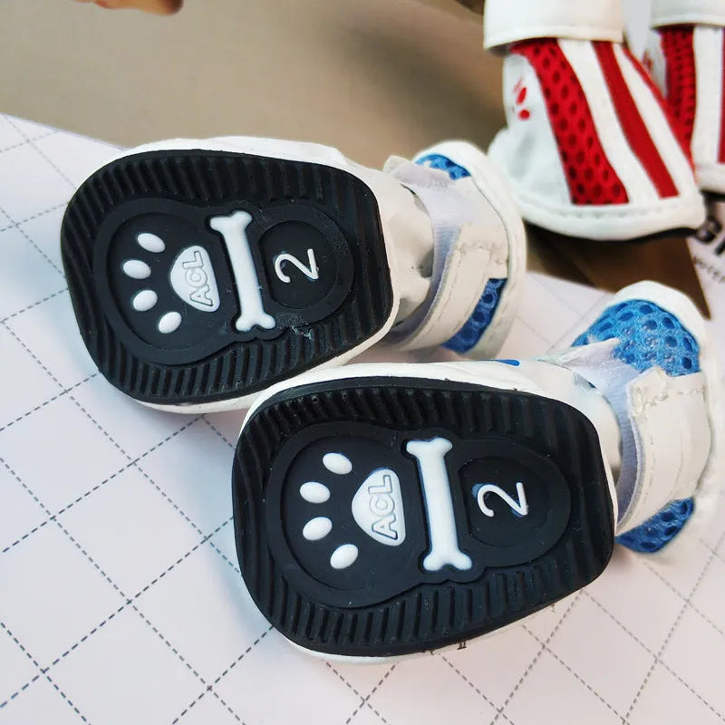 Four blue cloth dog shoes for small dogs with front zipper closure on a white background.