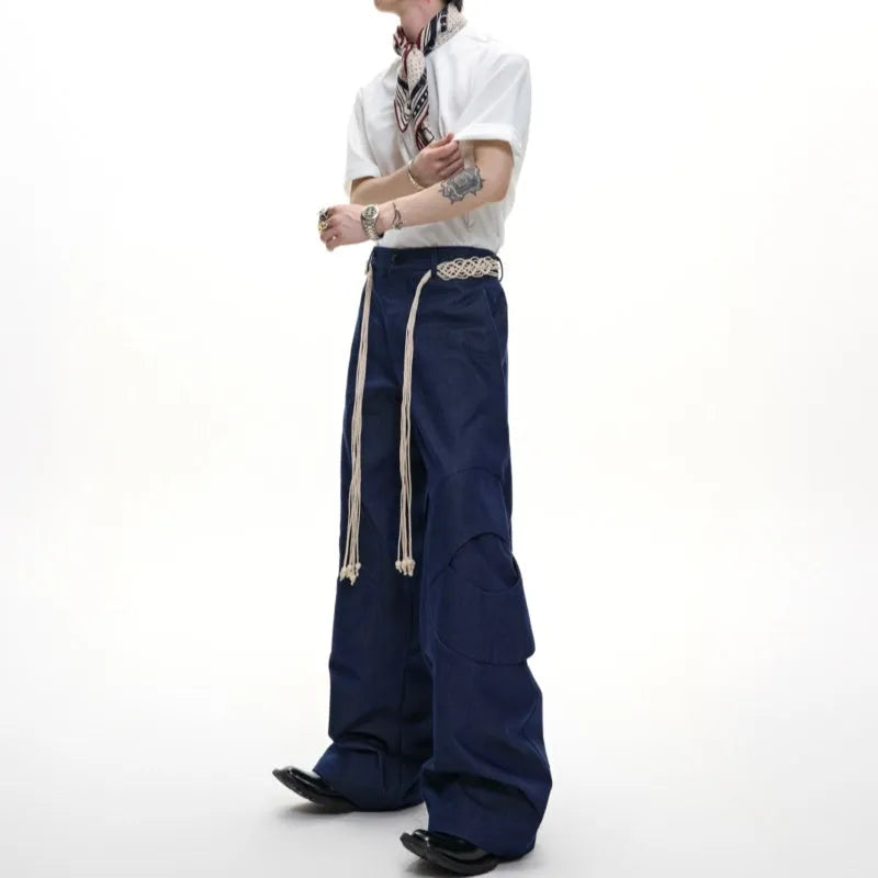 Men's dark blue straight-leg cotton jeans with heavy stitching on belt and zip decorations, shown in a loose fit.