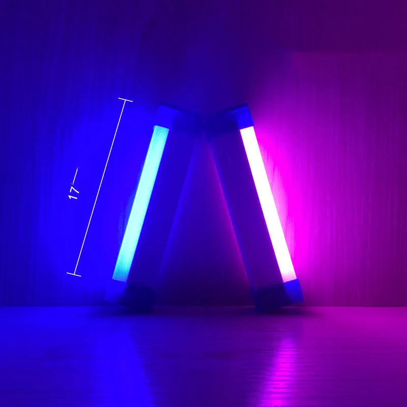 Rechargeable dimmable LED tube light in blue and purple colours shown in a bedroom setting.