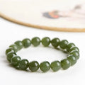 Hetian jade ball bracelet with polished beads in clear water colour on a string.