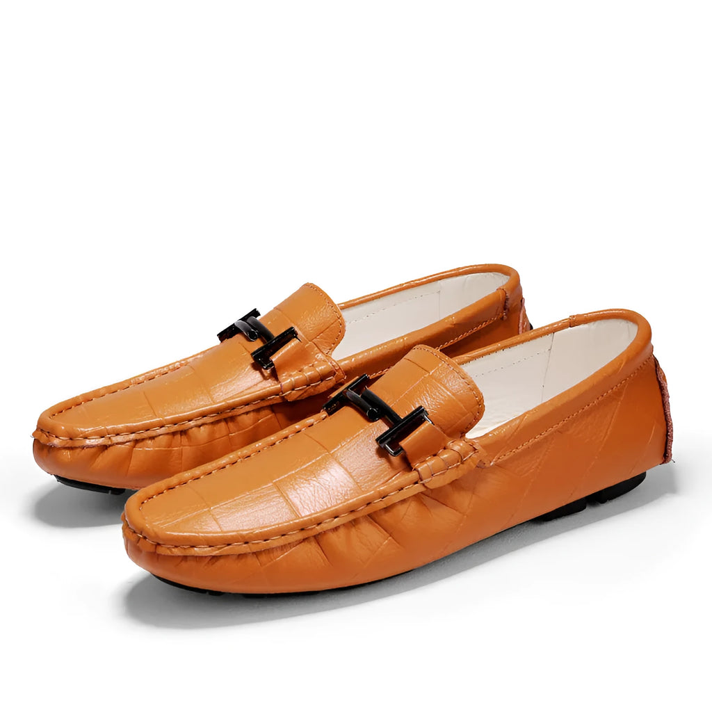 Men's brown leather casual loafers with a silver buckle on the front, shown from a side angle.