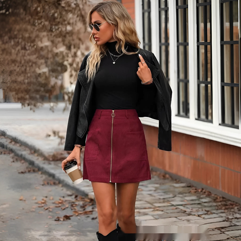 Women's black high-waist stitched zipper short hip skirt on a hanger.