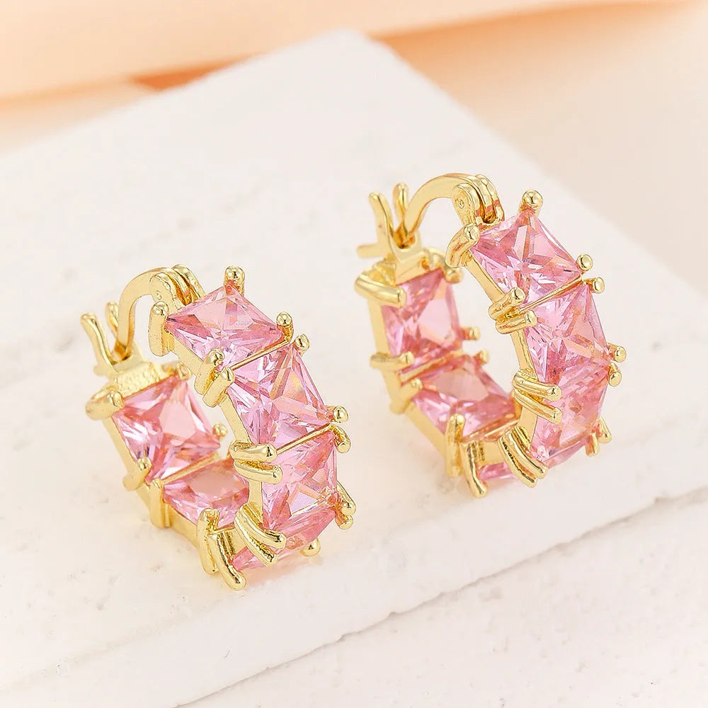Geometric U-shaped gold earrings with round accents and black zircon stones