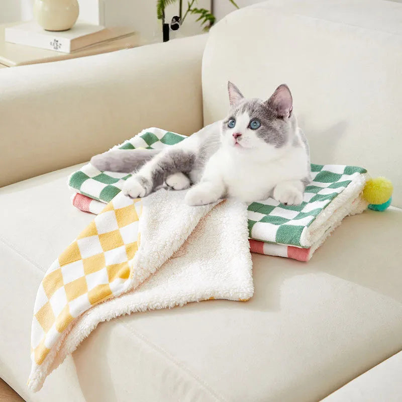 Plaid pattern pet blanket with fur ball trim on soft cotton fleece material for cats and dogs