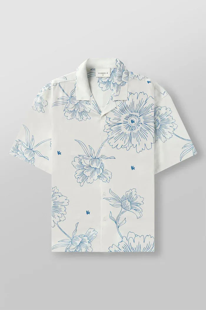 Man wearing a loose-fit, short sleeve floral print top in a neutral colour.