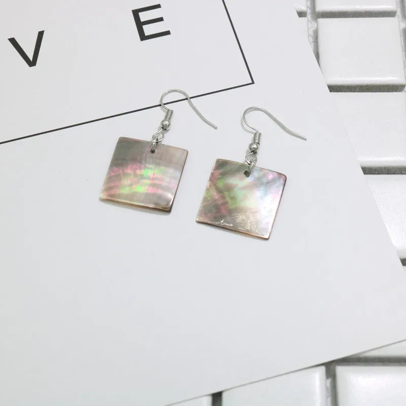 Women's geometric shell earrings in square panther or rectangular shell designs with natural material texture