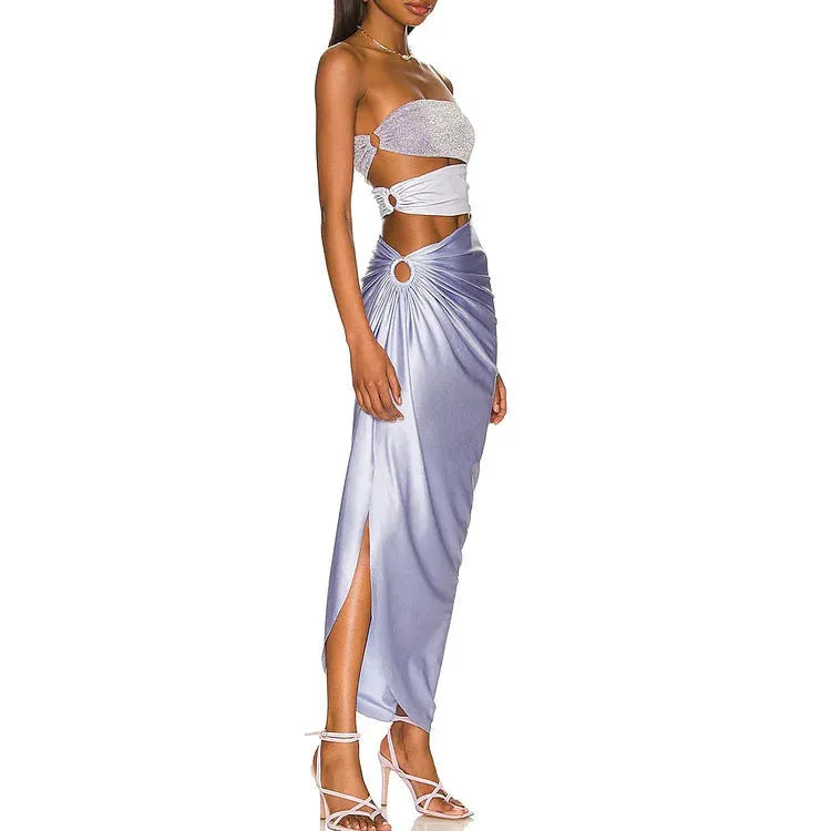 Purple one-piece swimsuit with hollow design and matching wrap skirt on white background