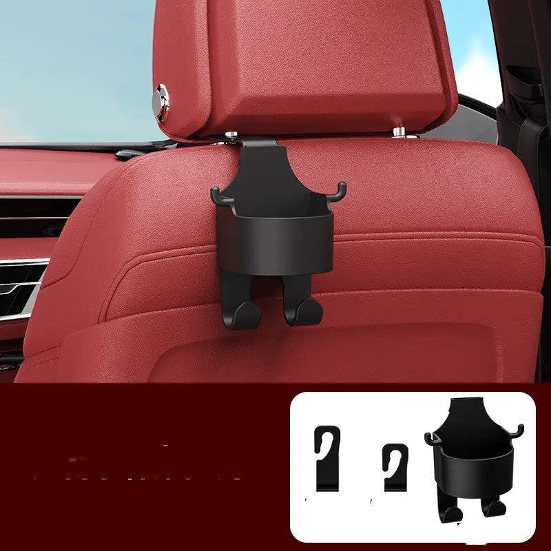 Black plastic car seat back organiser with cup holder and hanging hooks mounted on vehicle headrest