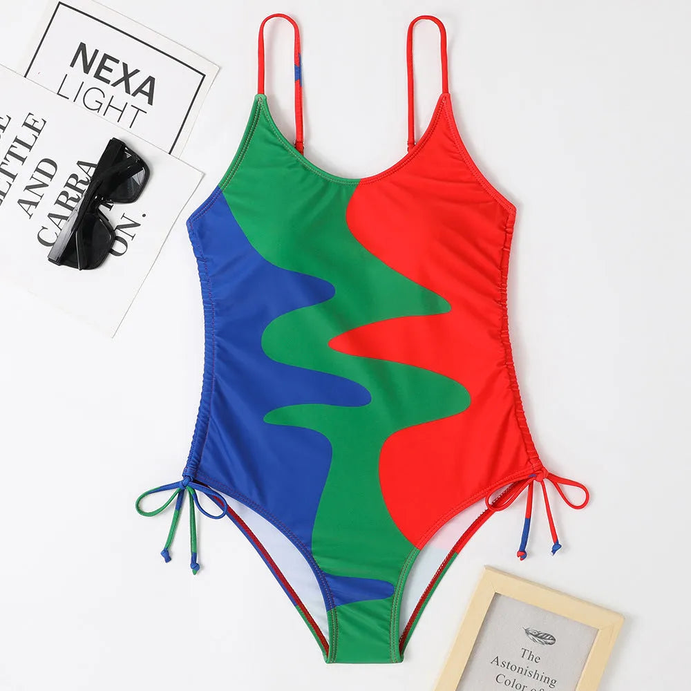 Women's sleeveless one-piece swimsuit in blue with backless design and striped pattern