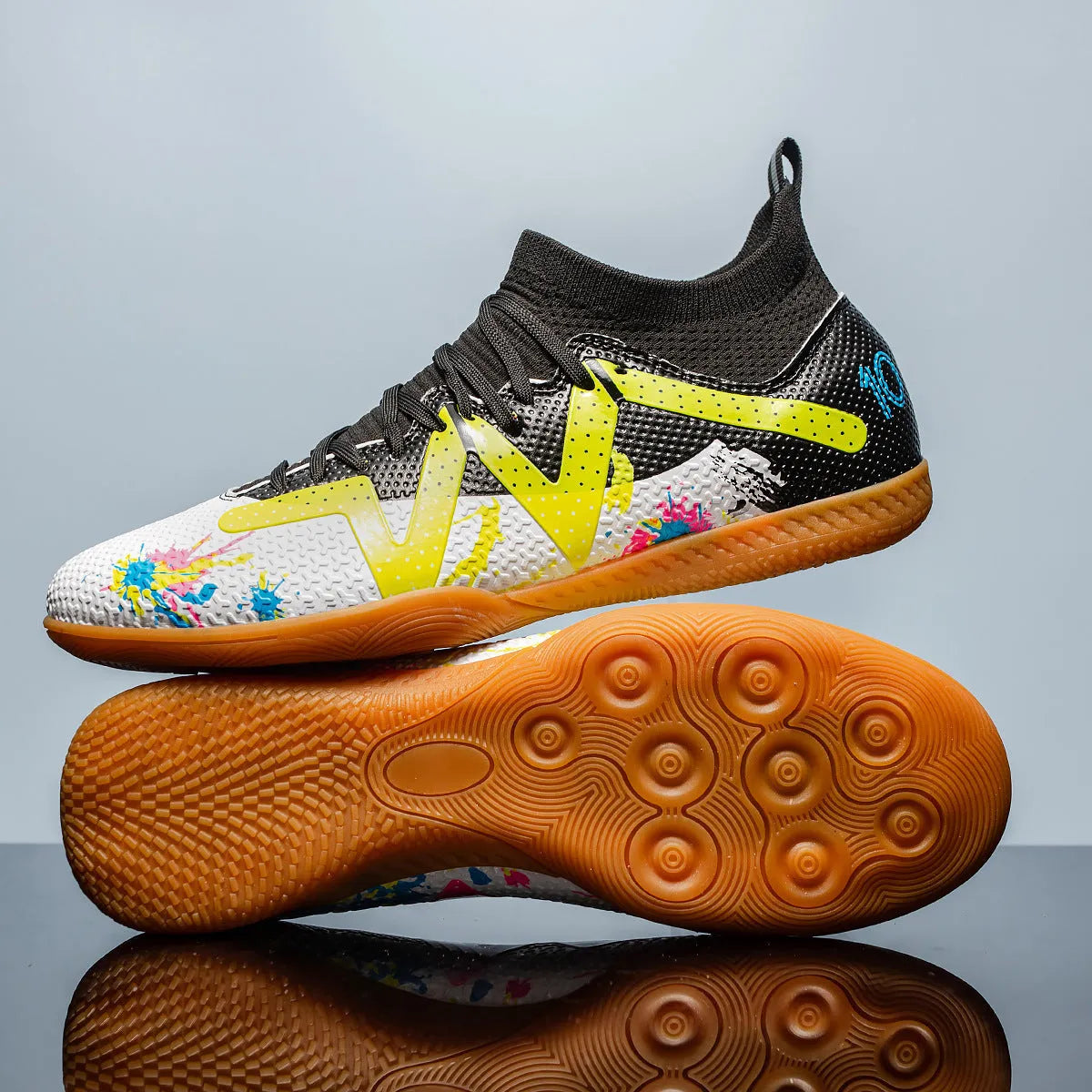 Adult low-top football boots with non-slip rubber outsole, available in black and yellow, white, and black colourways.