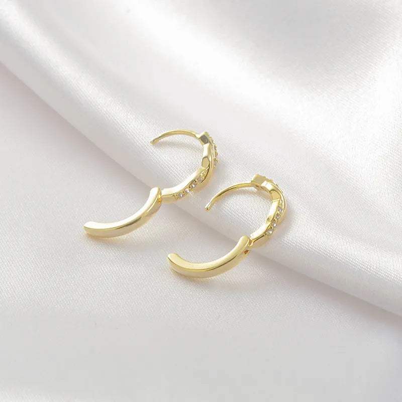 Geometric interwoven hemp rope earrings in copper with gold finish and earclip fastening