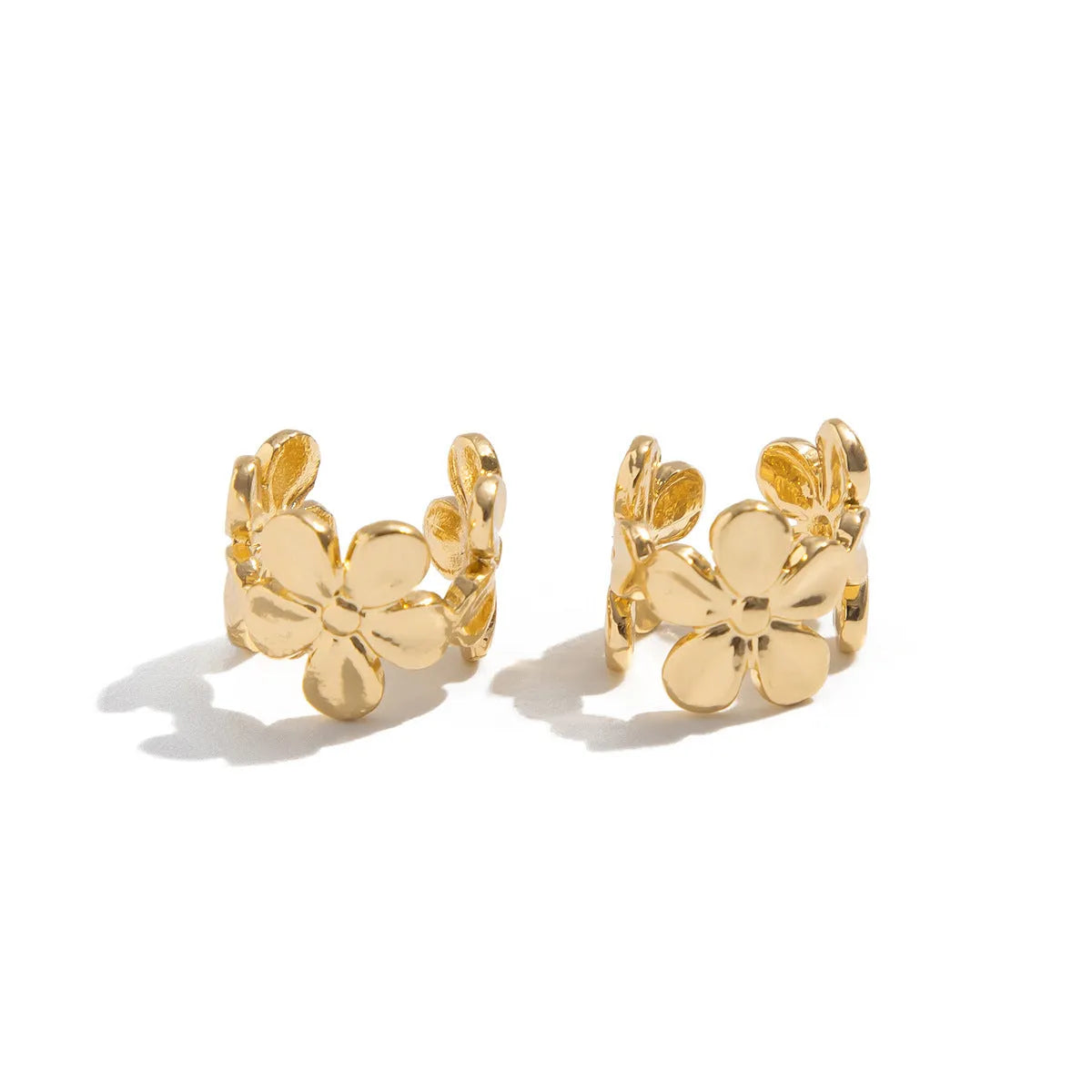 A pair of gold drop earrings featuring starfish and conch designs on an alloy base.