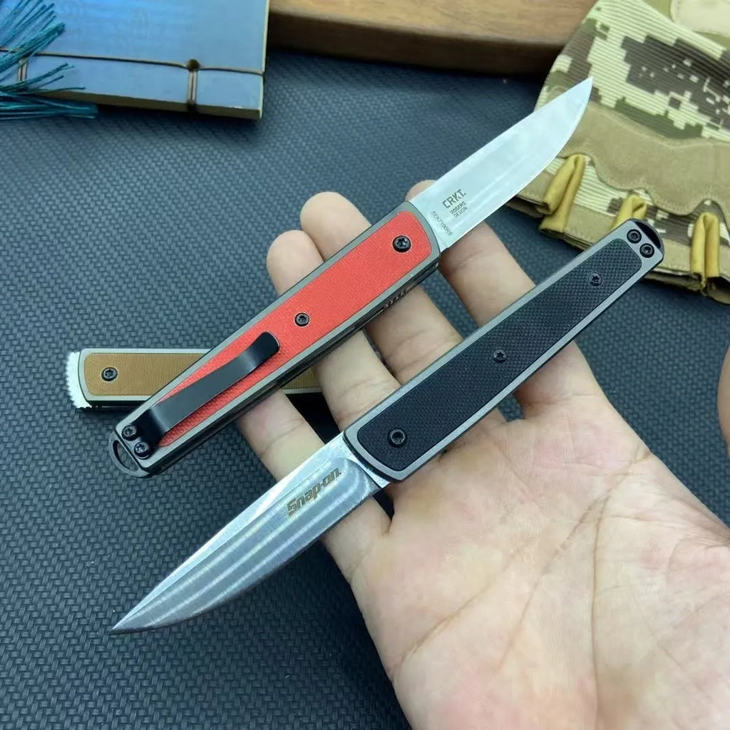 Folding fruit knife with stainless steel blade in black, brown, or red colour options showing closed and open positions