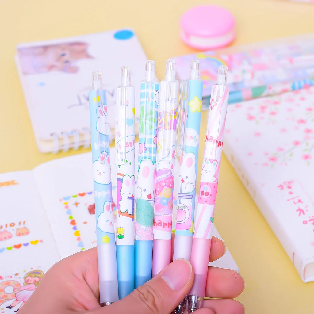 Set of six white plastic pens with black caps and a cartoon bunny character printed on the barrel.