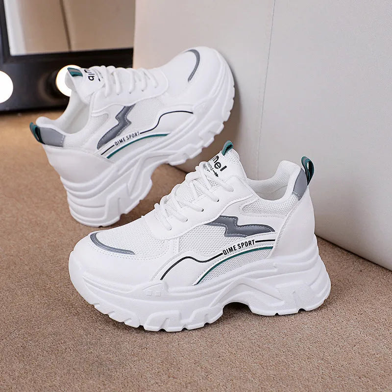White women's dad shoes with cross shoulder straps, breathable mesh, and a rubber sole.