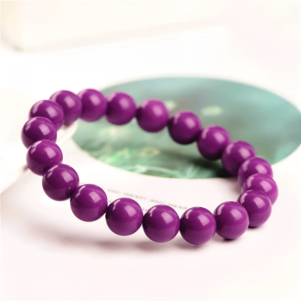 Jiuya original design purple mica crystal bracelet on a wrist, showing polished beads in a single circle.