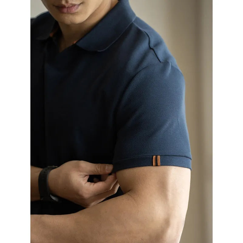 Man's blue American-style short-sleeved cotton blend polo shirt on a hanger.